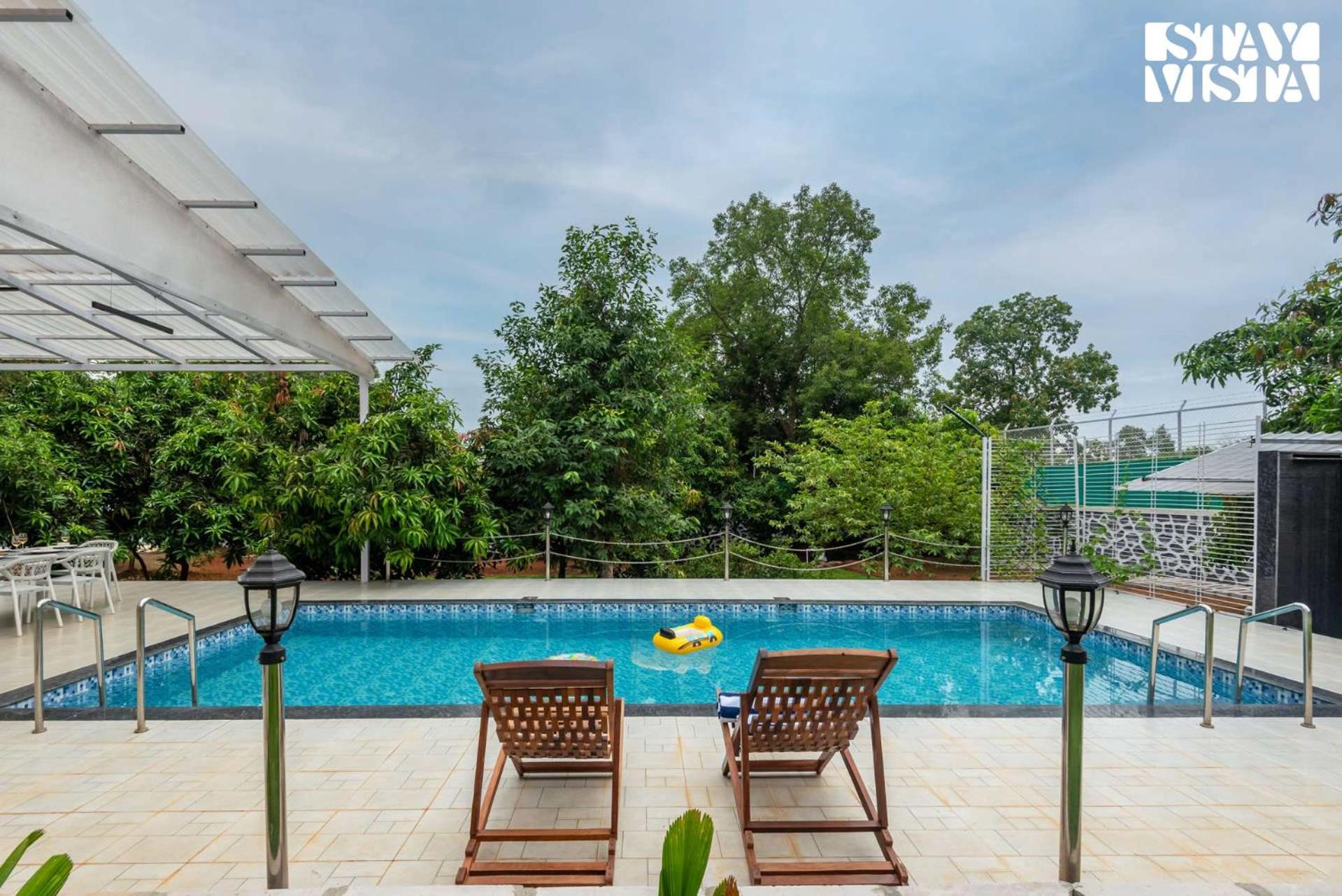 Grey Hues With Swimming Pool & Lawn At By Stayvista Karjat